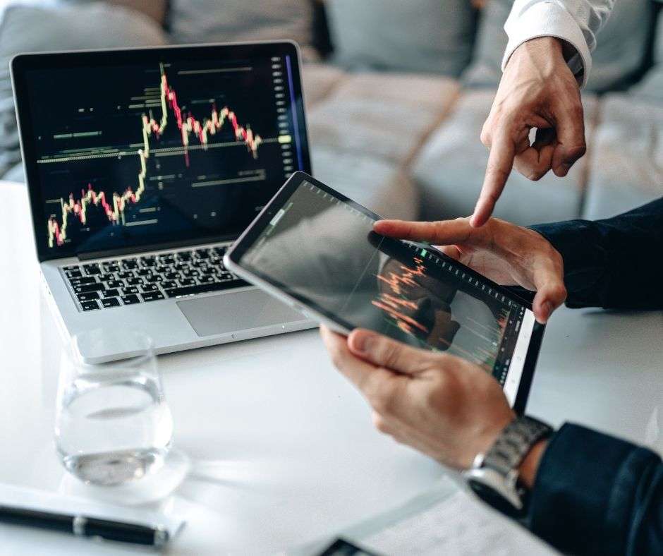People with laptops, discussing crypto asset management